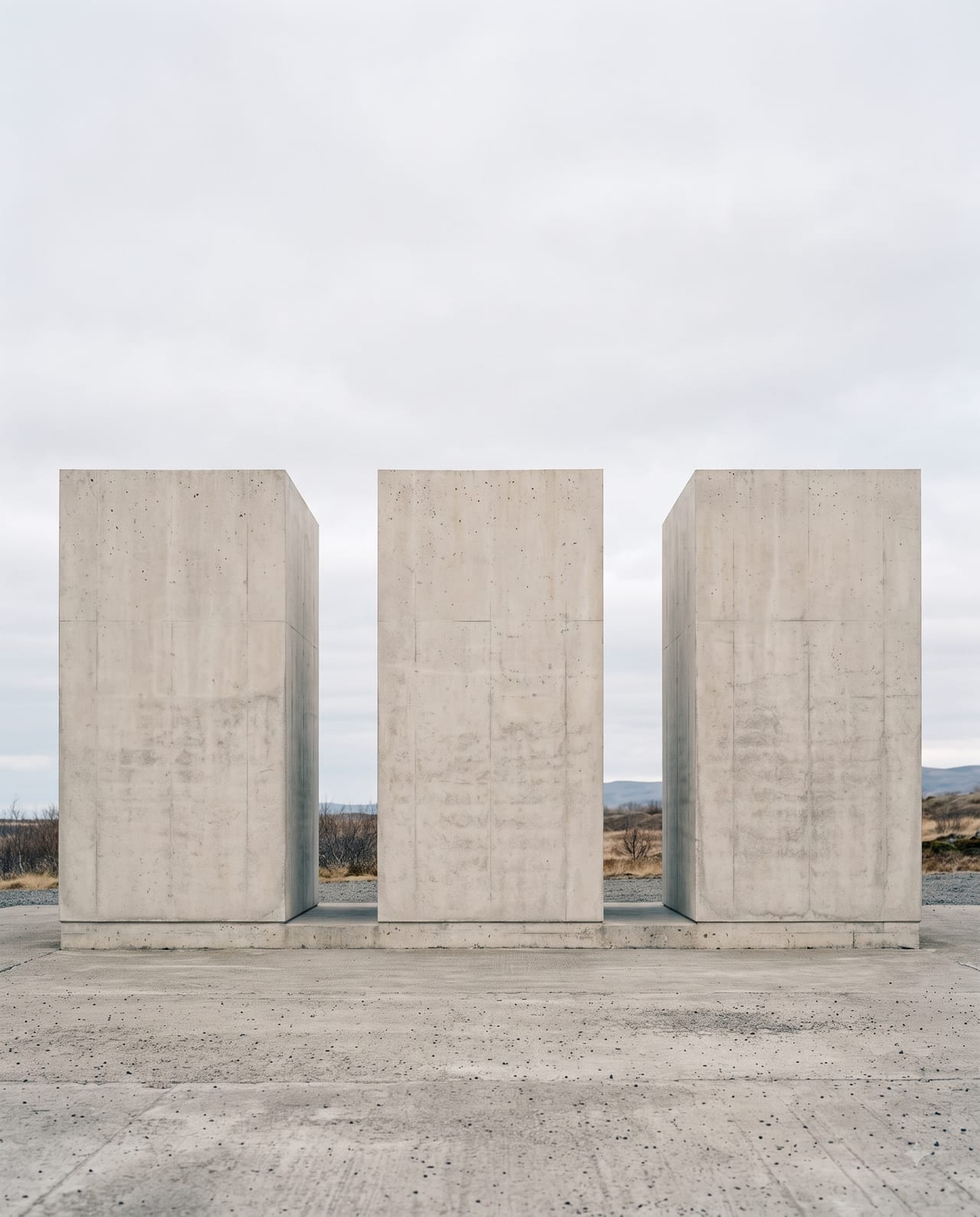 Three separate concrete volumes with open gaps between them.